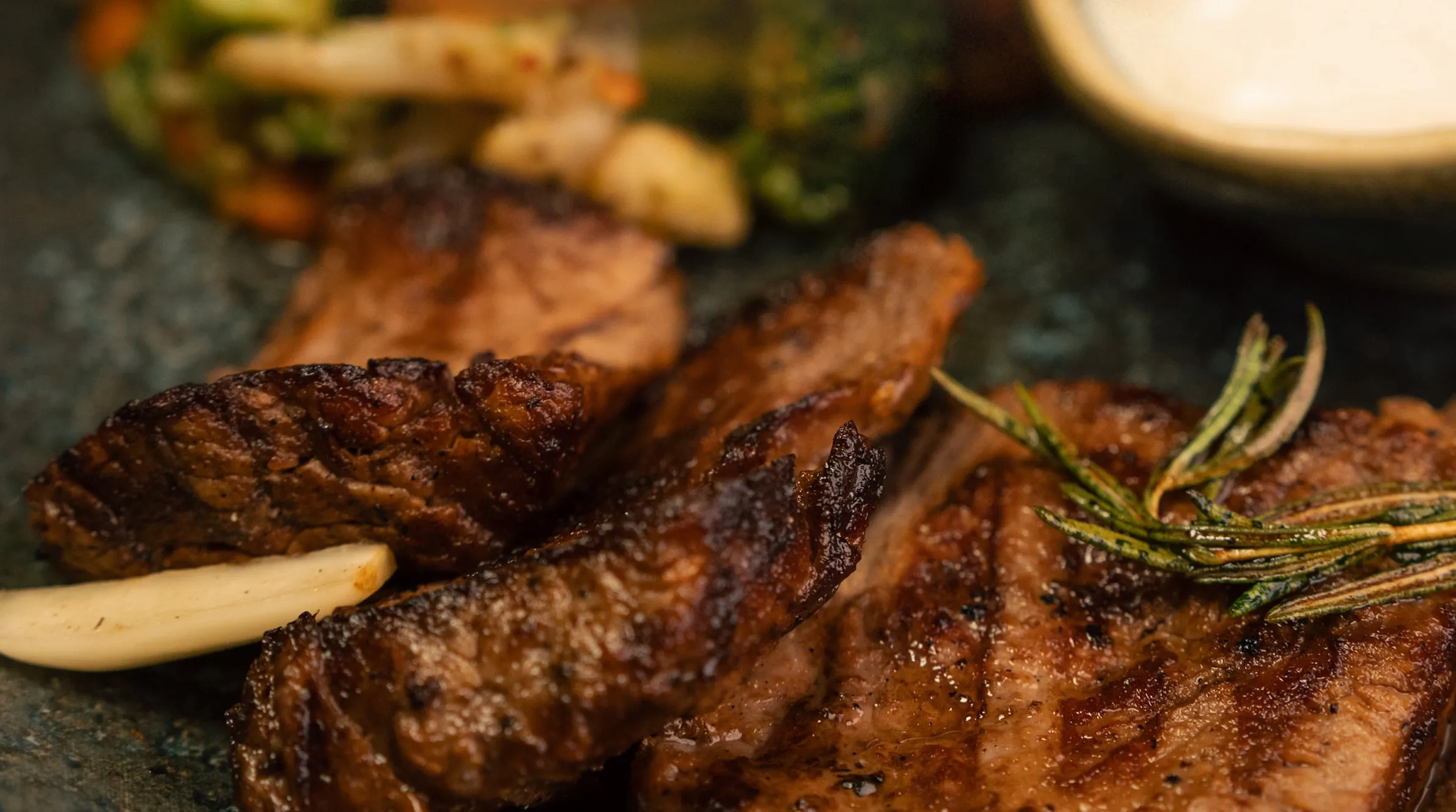 Grilled steak with roasted garlic and rosemary, the photograph from the cover of our printed menu