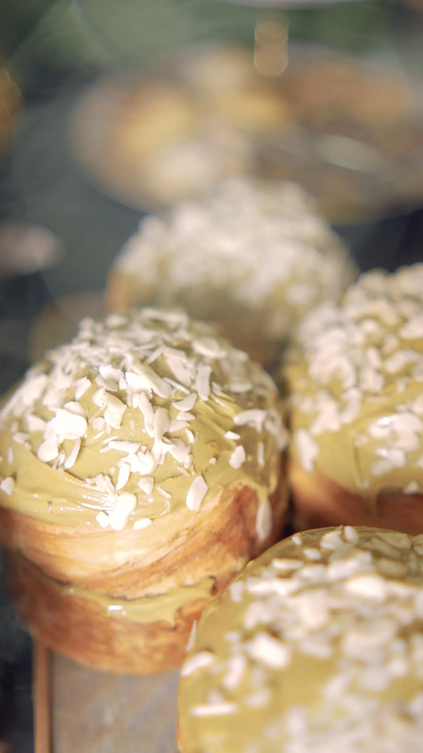 Croissants glazed with pistachio cream and covered in flaked almonds
